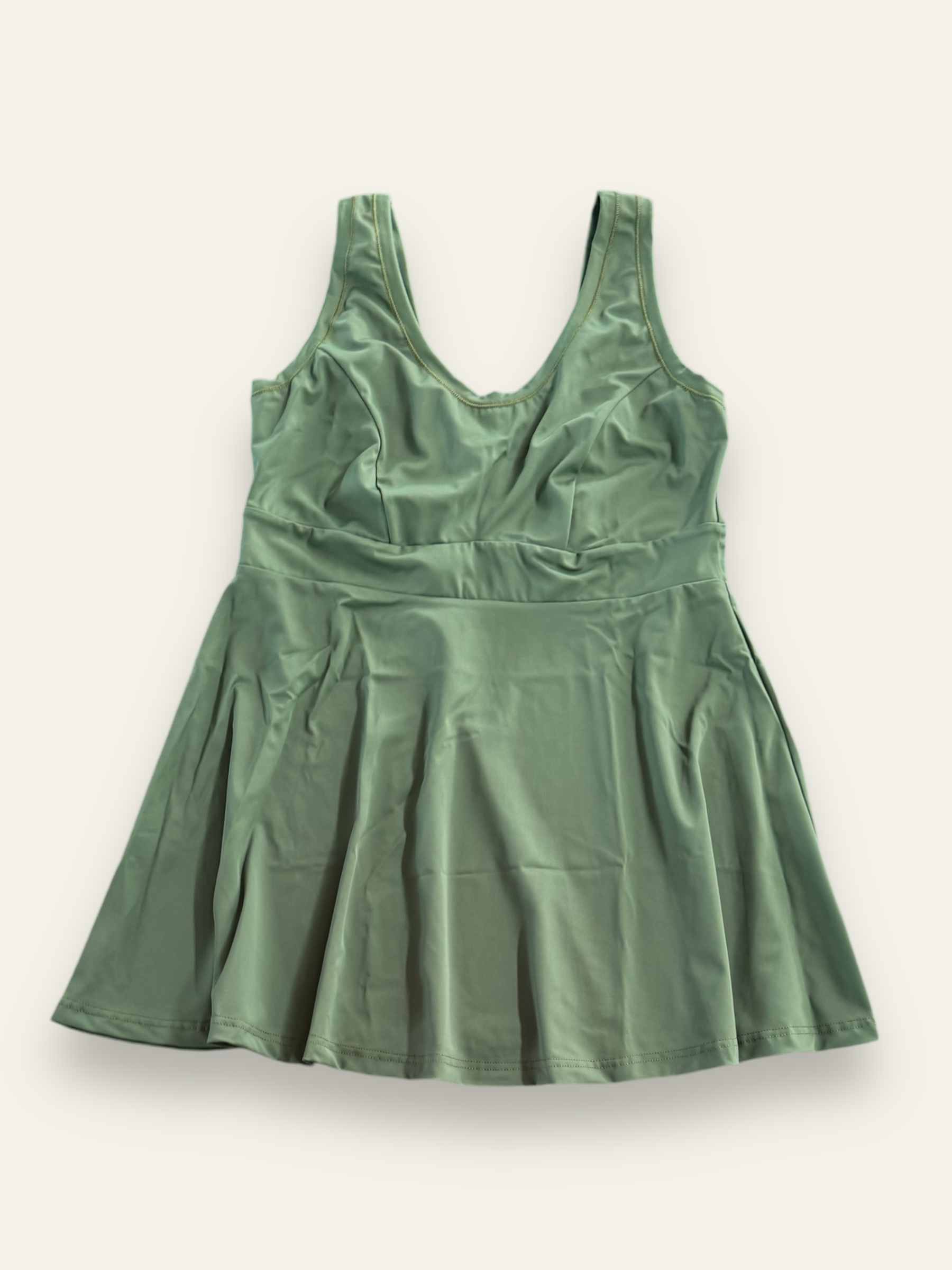 army green swim dress laying flat on cream background